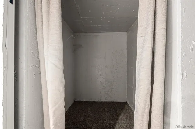 a bathroom with a granite countertop toilet sink and mirror