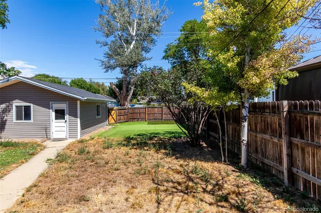 a view of house with backyard