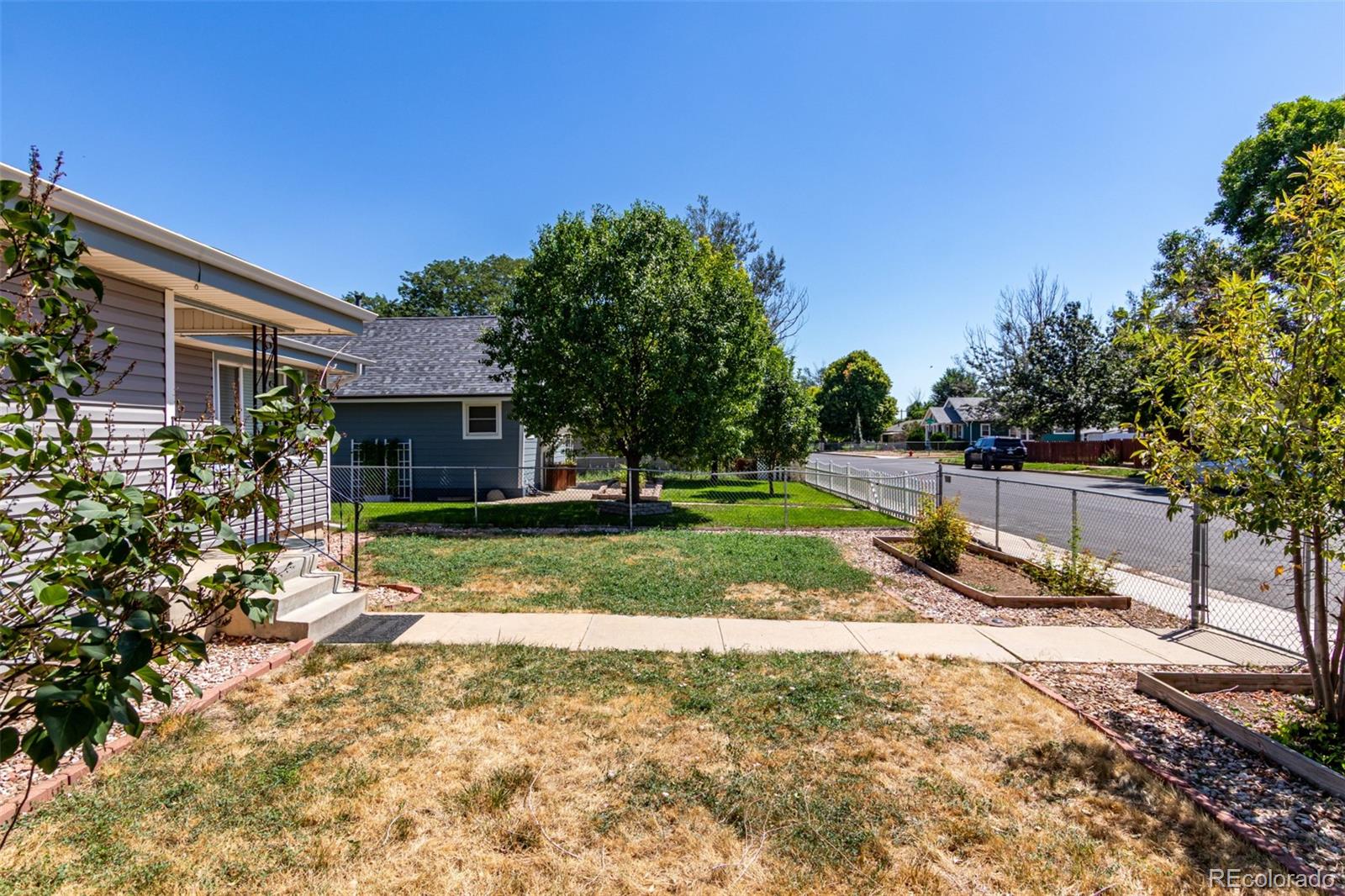 117 6th Street Frederick, CO 80530 - Photo 4 of 43 a view of a backyard with a slide