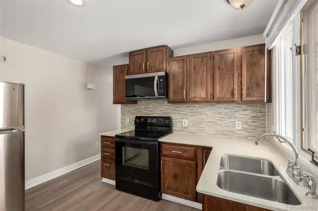 a kitchen with granite countertop a sink and steel appliances