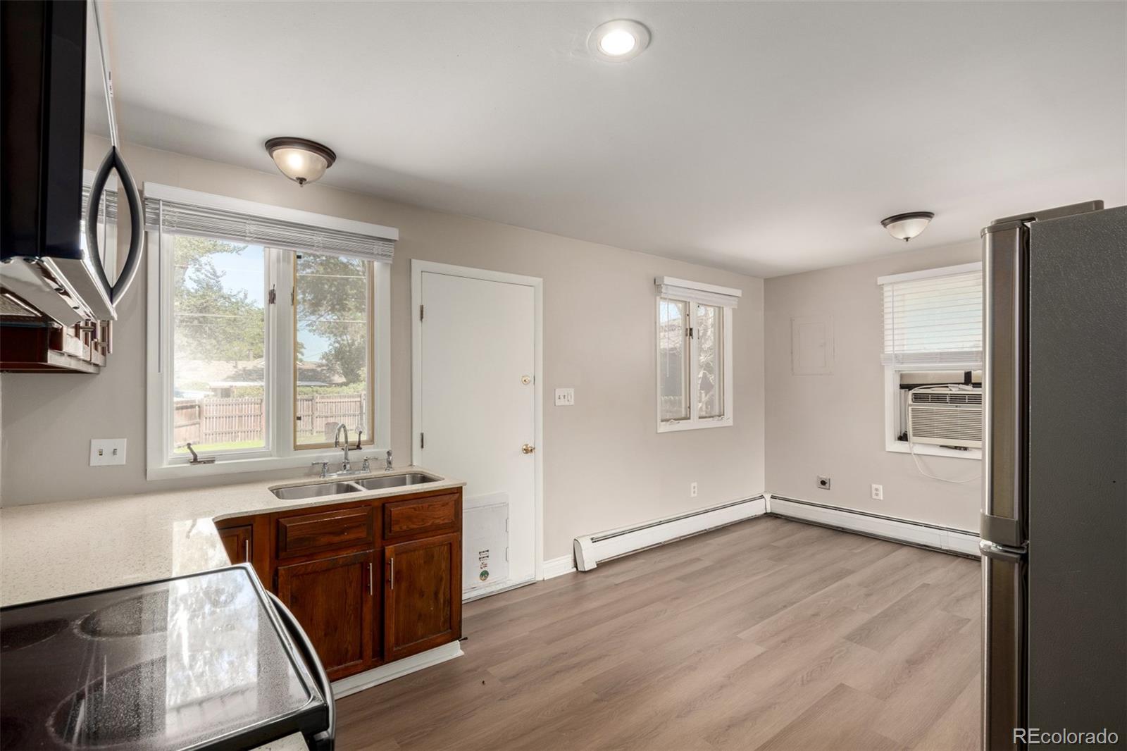 117 6th Street Frederick, CO 80530 - Photo 10 of 43 a view of an empty room with a window and wooden floor