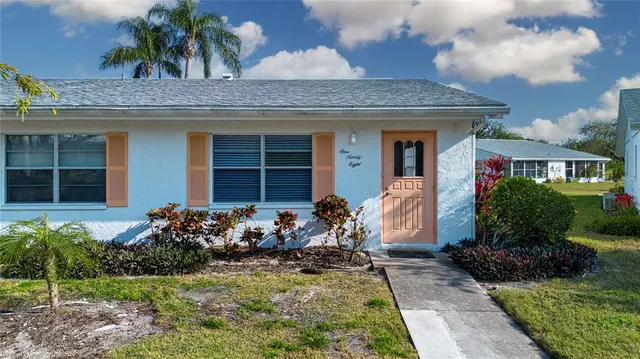 an aerial view of a house with yard swimming pool and outdoor seating