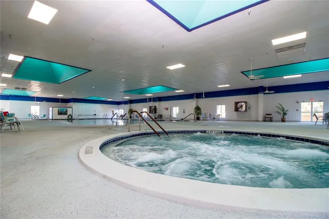 a view of a swimming pool and lounge chair