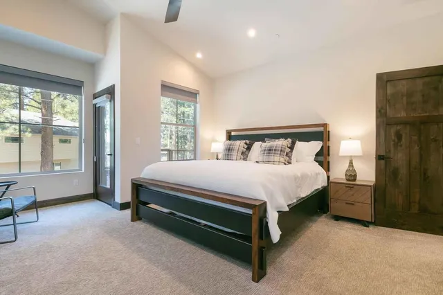 a bed sitting in a bedroom next to a window