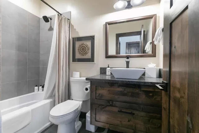 a bathroom with a sink toilet a mirror and shower