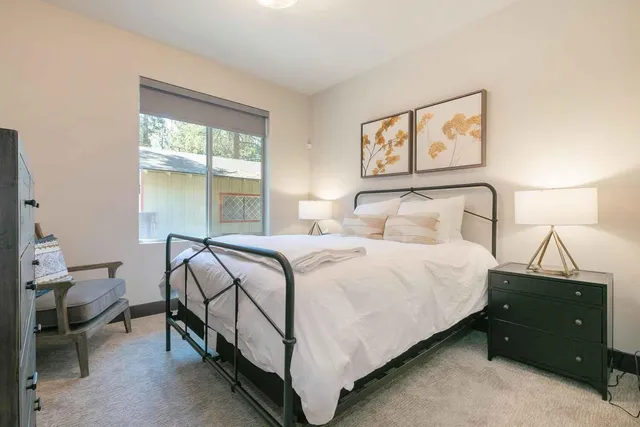 a bedroom with a bed and a window