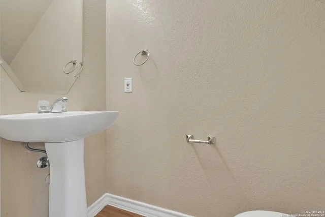 a bathroom with a sink mirror and toilet