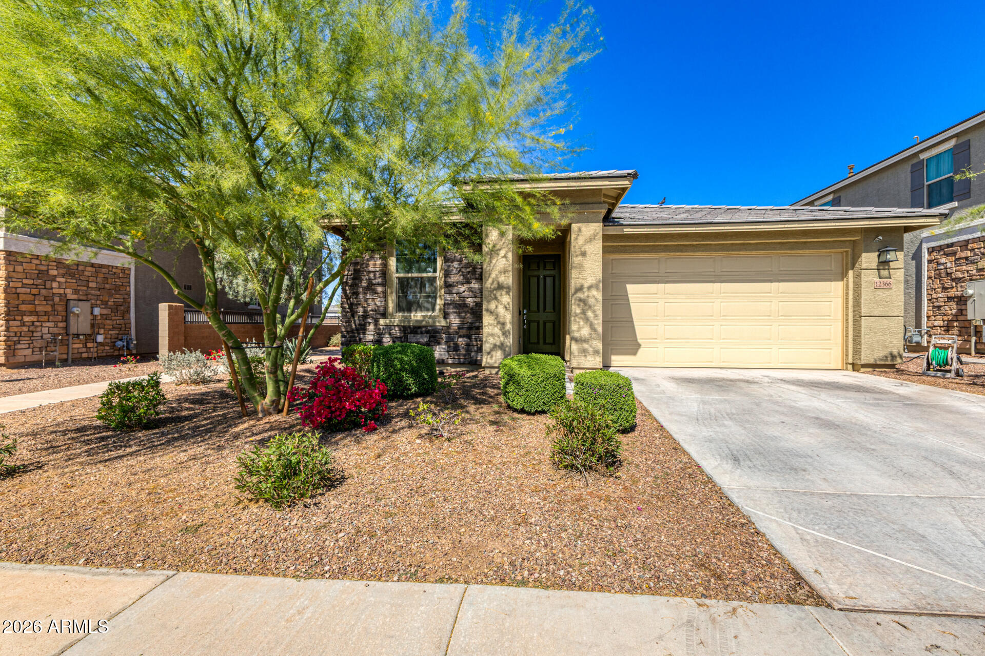 Undisclosed Address Avondale, AZ 85323 - Photo 1 of 32 a front view of a house with garden