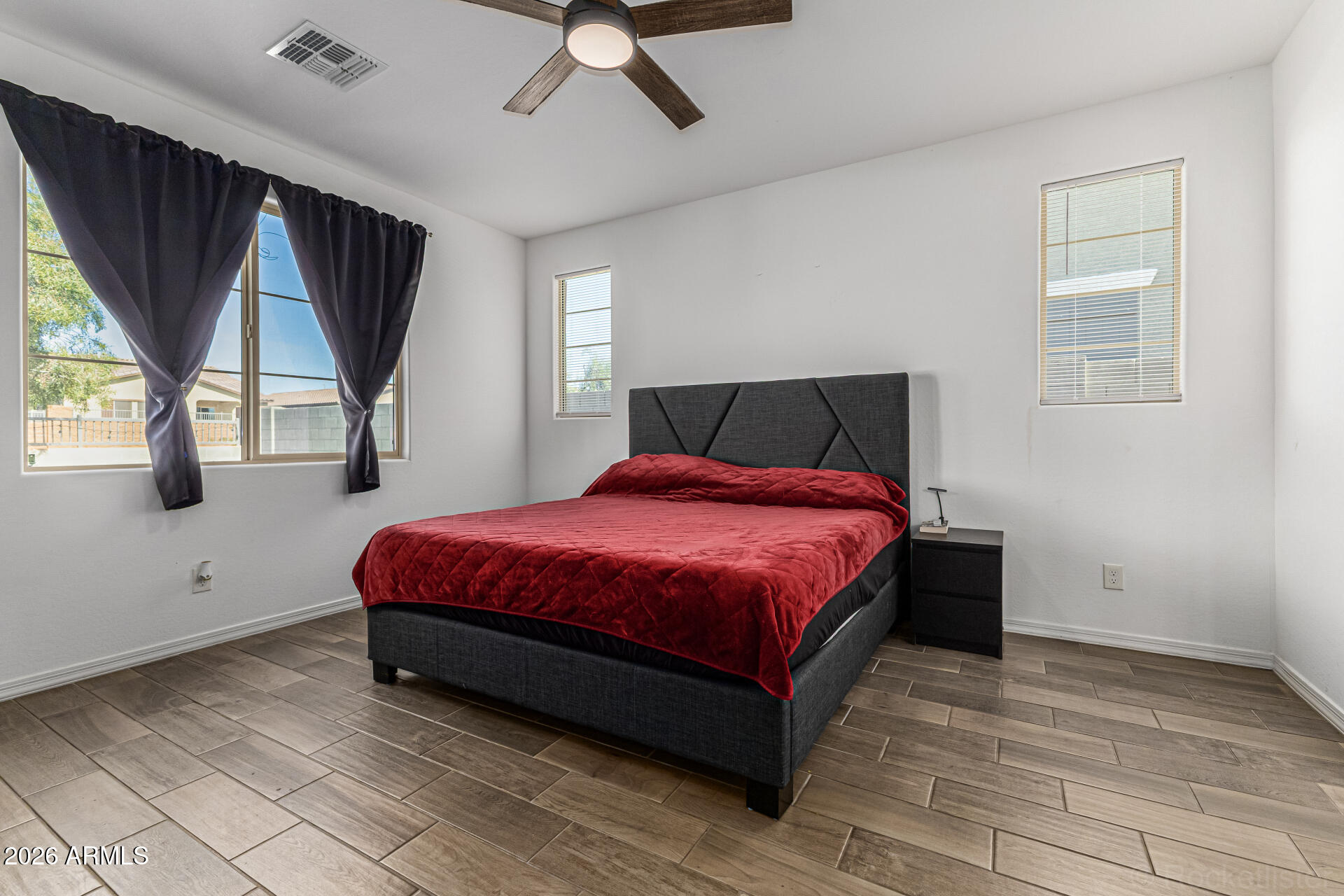Undisclosed Address Avondale, AZ 85323 - Photo 12 of 32 a spacious bedroom with a bed and window