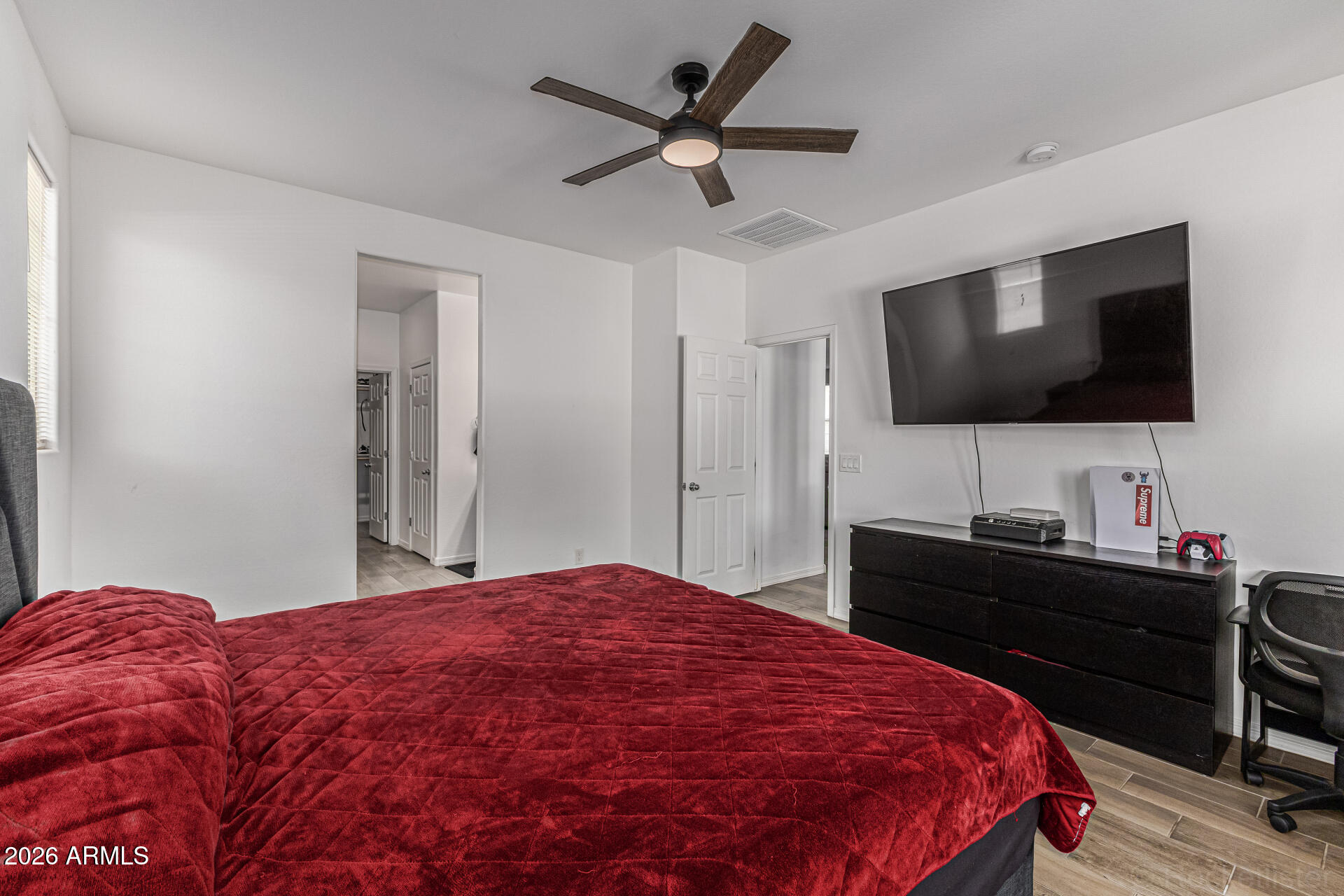 Undisclosed Address Avondale, AZ 85323 - Photo 14 of 32 a bedroom with a bed and a flat screen tv