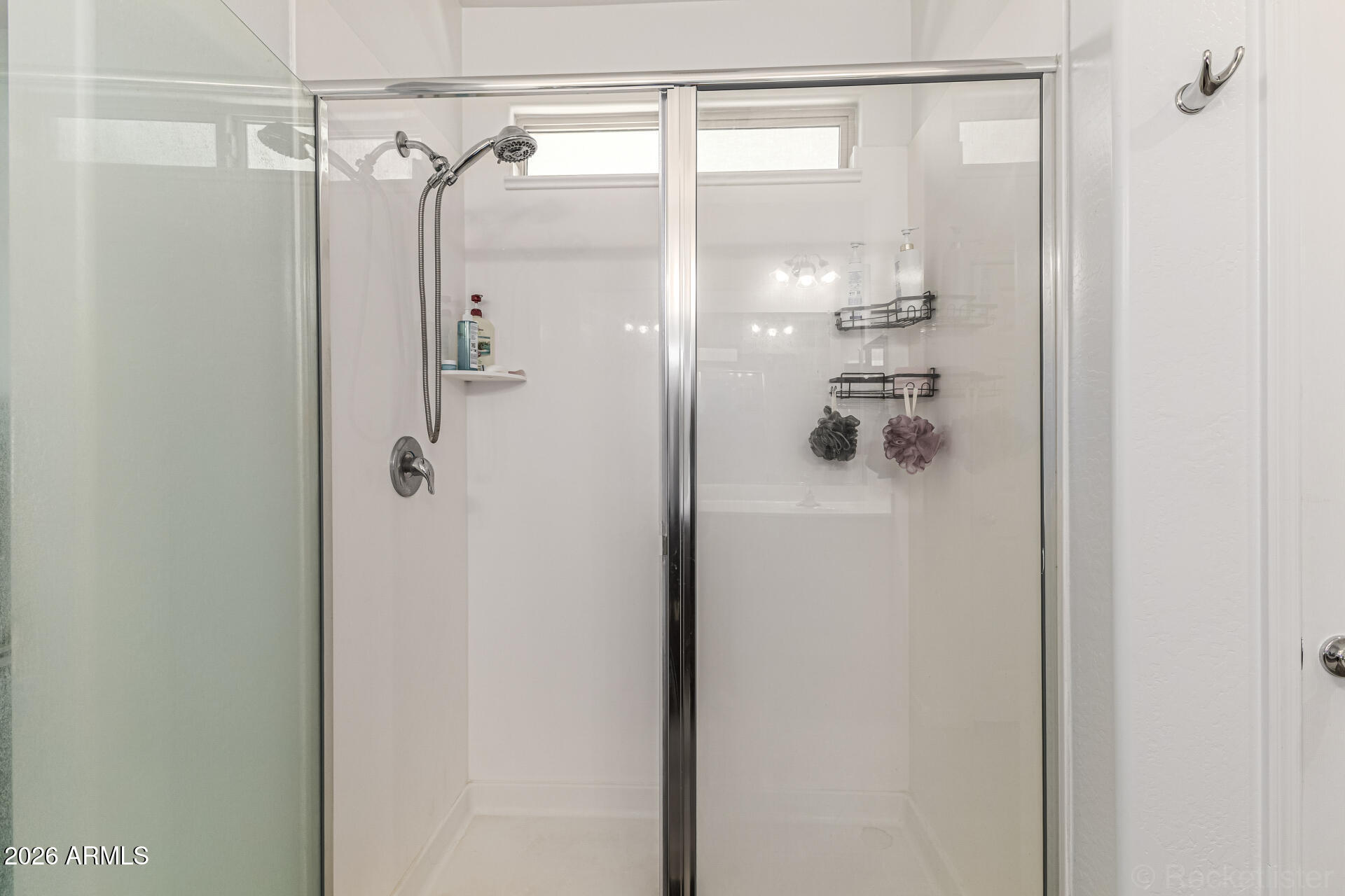 Undisclosed Address Avondale, AZ 85323 - Photo 17 of 32 a bathroom with a glass shower door