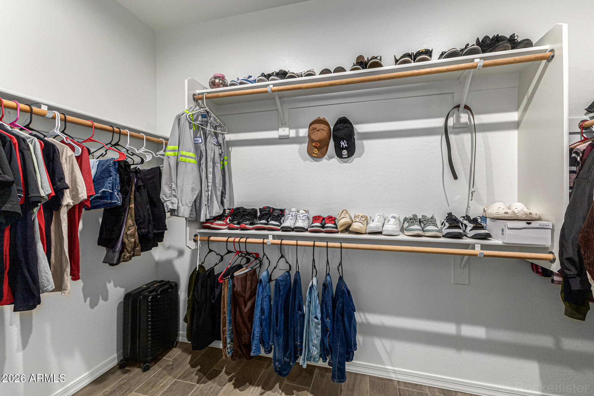 Undisclosed Address Avondale, AZ 85323 - Photo 18 of 32 a view of walk in closet with clothes and shoes
