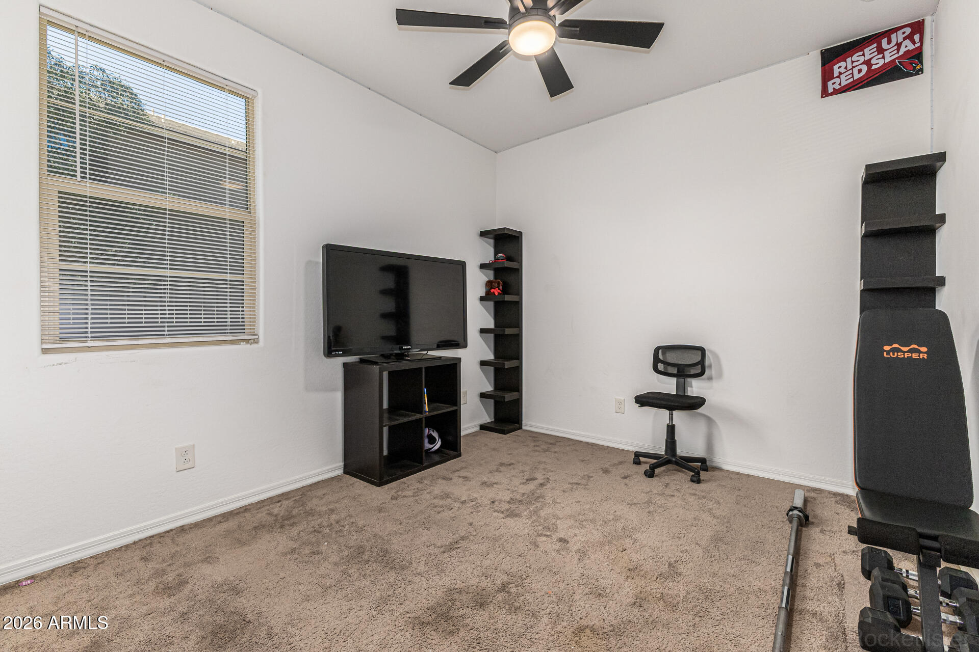 Undisclosed Address Avondale, AZ 85323 - Photo 20 of 32 a living room with furniture and a flat screen tv