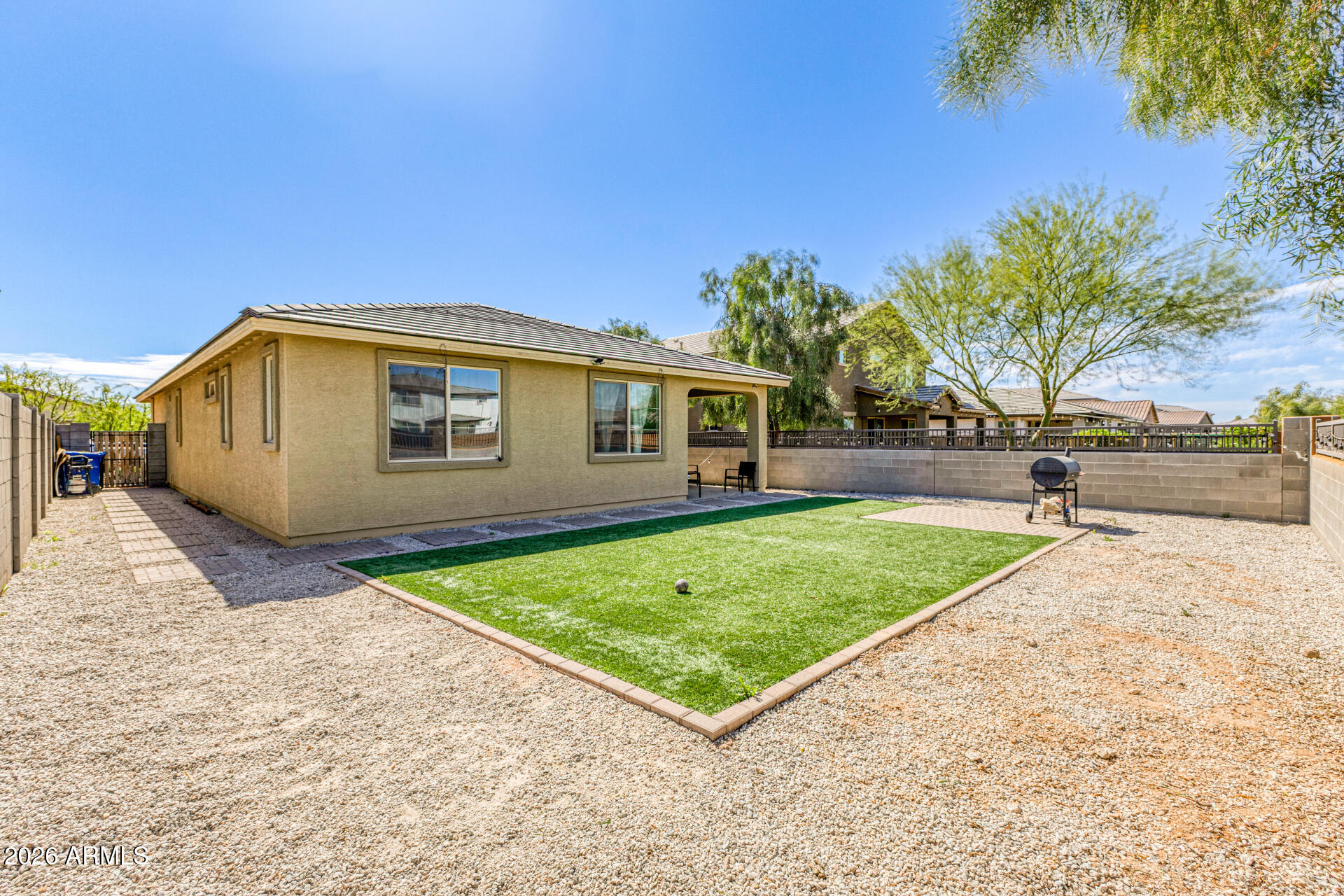 Undisclosed Address Avondale, AZ 85323 - Photo 30 of 32 a view of a backyard with a garden and tree