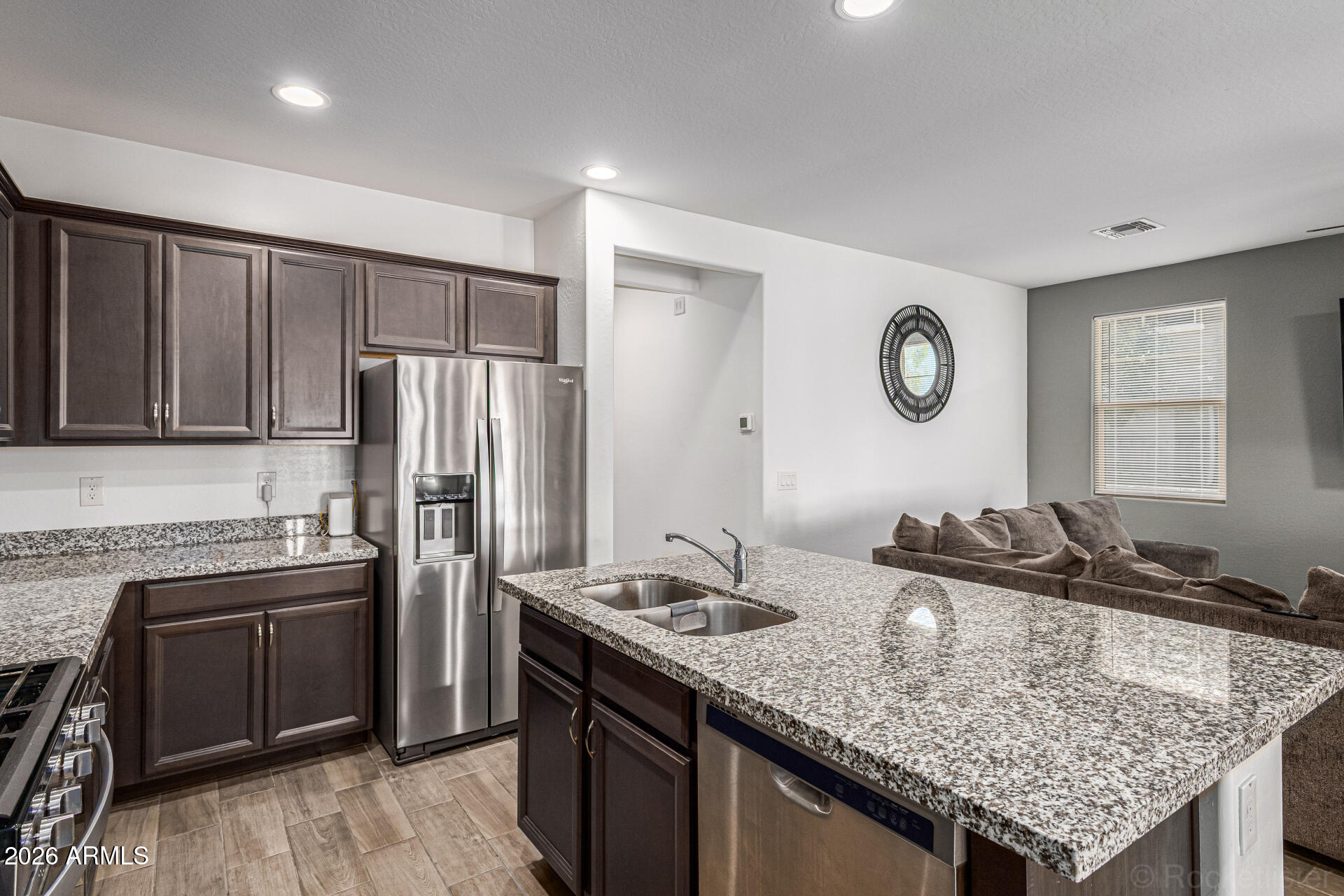 Undisclosed Address Avondale, AZ 85323 - Photo 4 of 32 a kitchen with stainless steel appliances granite countertop a sink stove and refrigerator