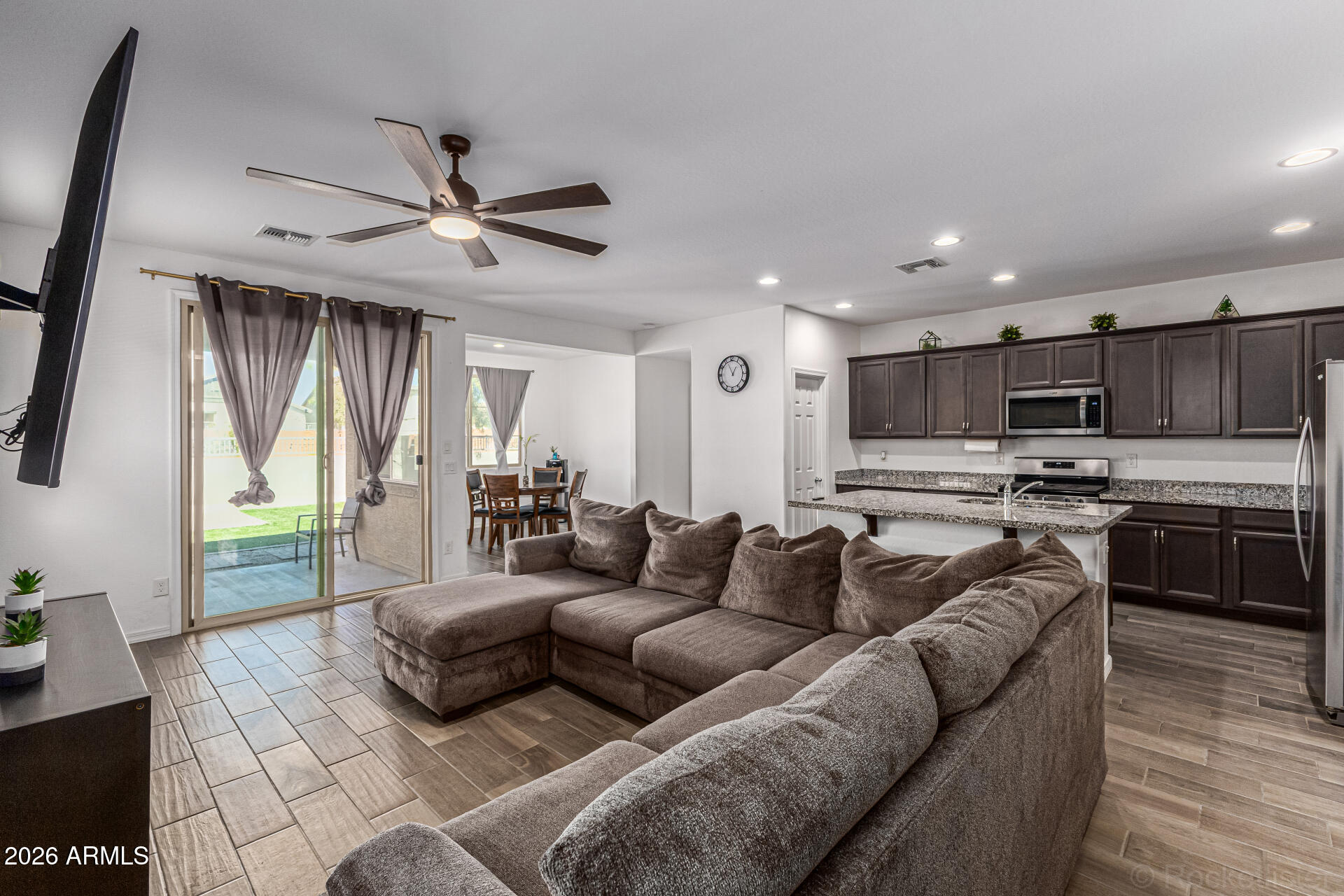 Undisclosed Address Avondale, AZ 85323 - Photo 7 of 32 a living room with furniture kitchen and a wooden floor