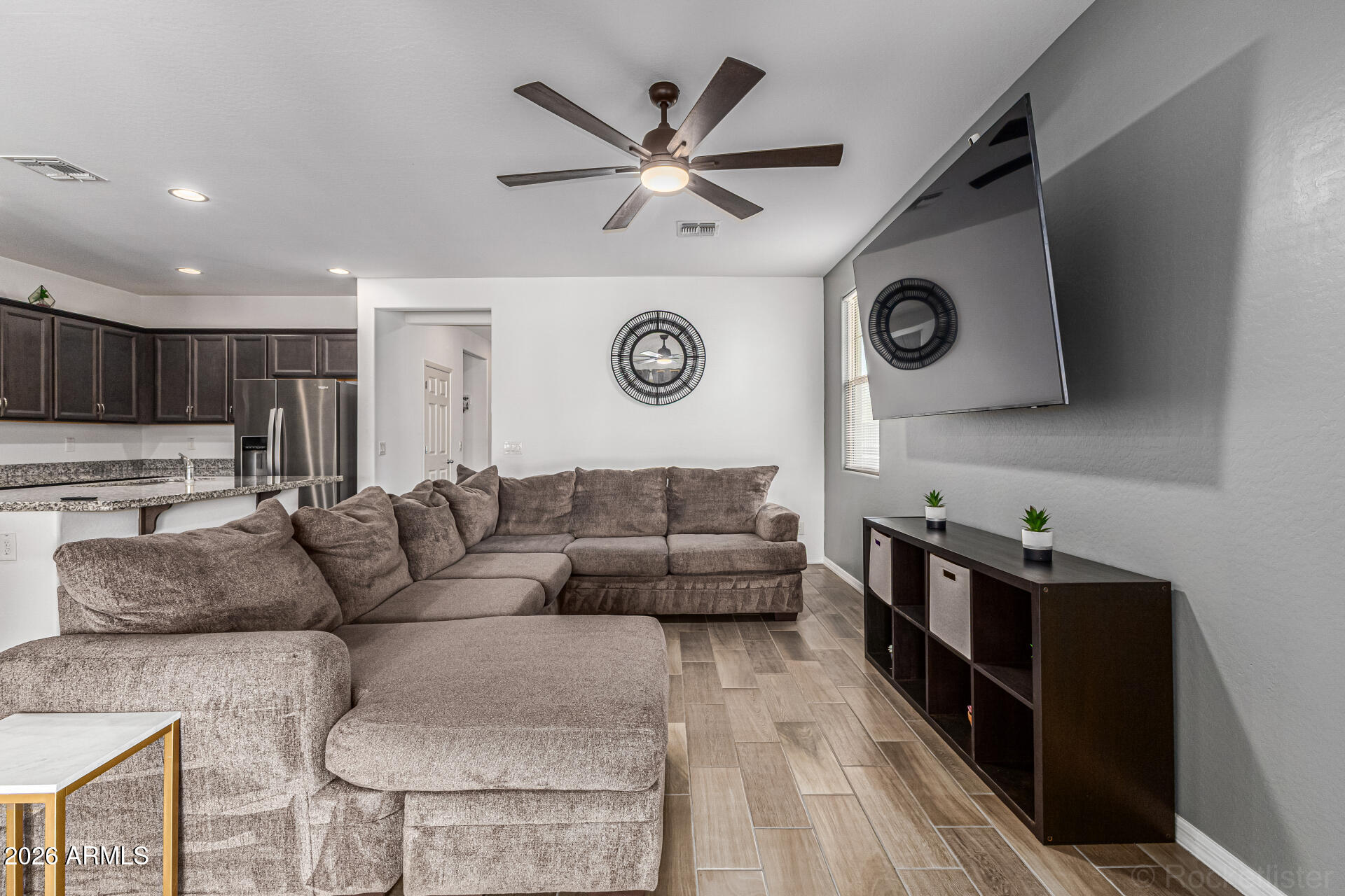 Undisclosed Address Avondale, AZ 85323 - Photo 9 of 32 a living room with furniture and kitchen view