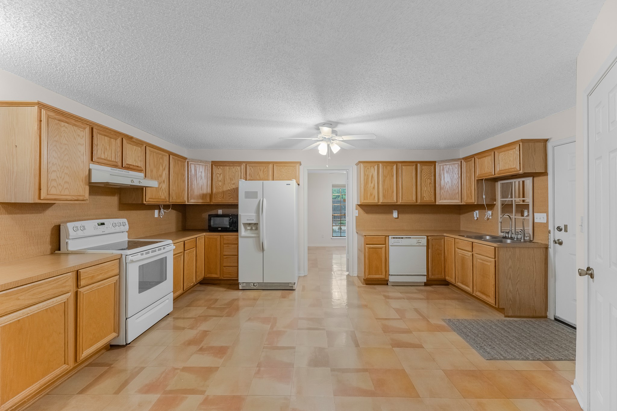 7315 Pine Street Manvel, TX 77578 - Photo 42 of 50 a kitchen with a refrigerator and cabinets