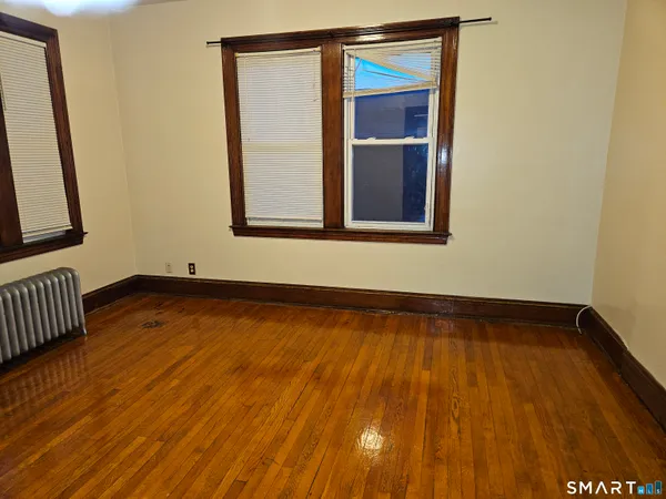 a view of a room with wooden floor and small door
