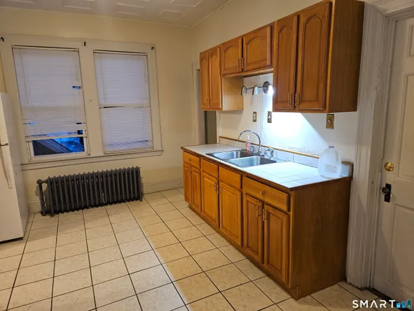 a kitchen with stainless steel appliances granite countertop a sink and cabinets