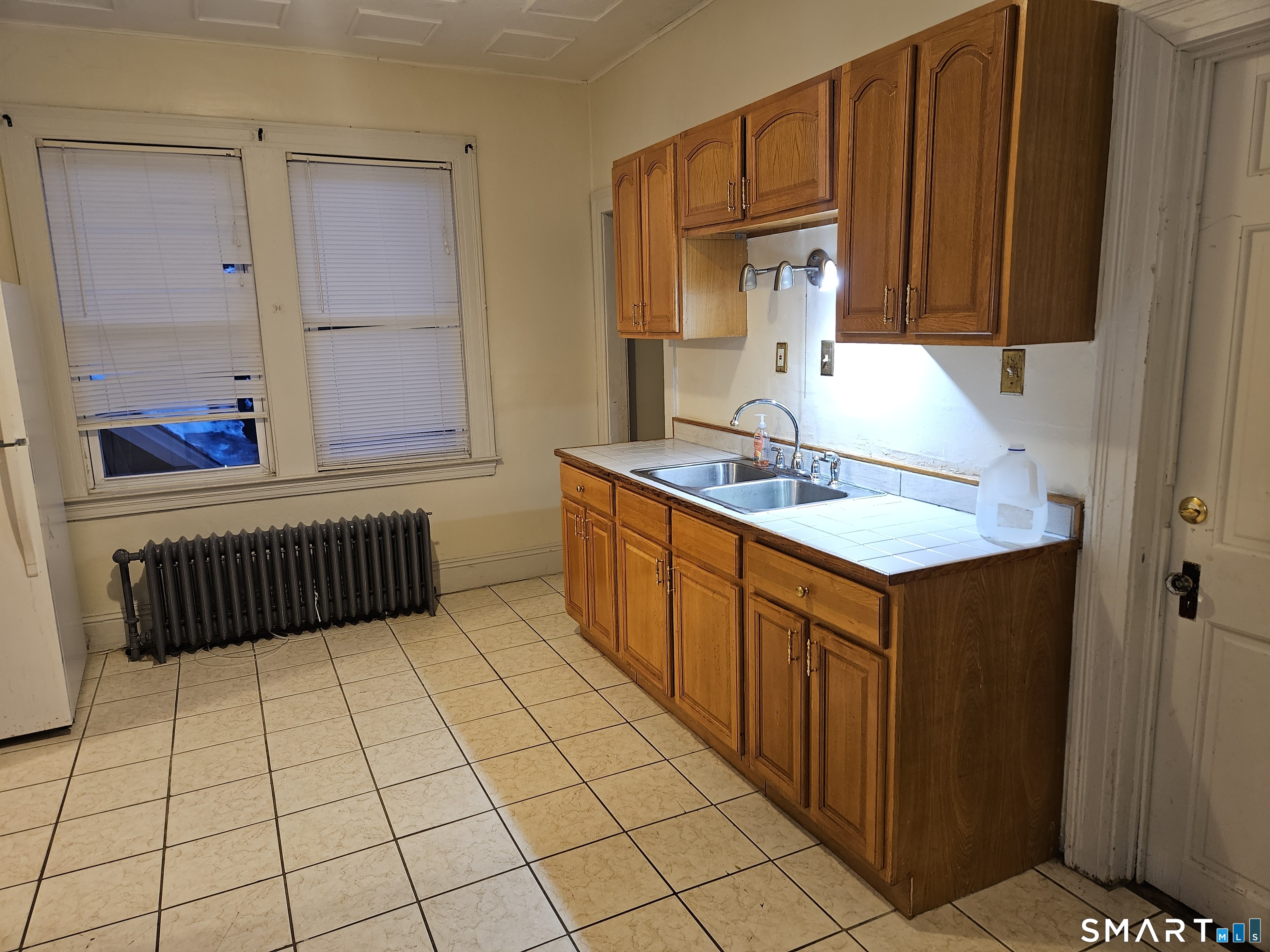 103 Kent Street Hartford, CT 06112 - Photo 7 of 9 a kitchen with stainless steel appliances granite countertop a sink and cabinets