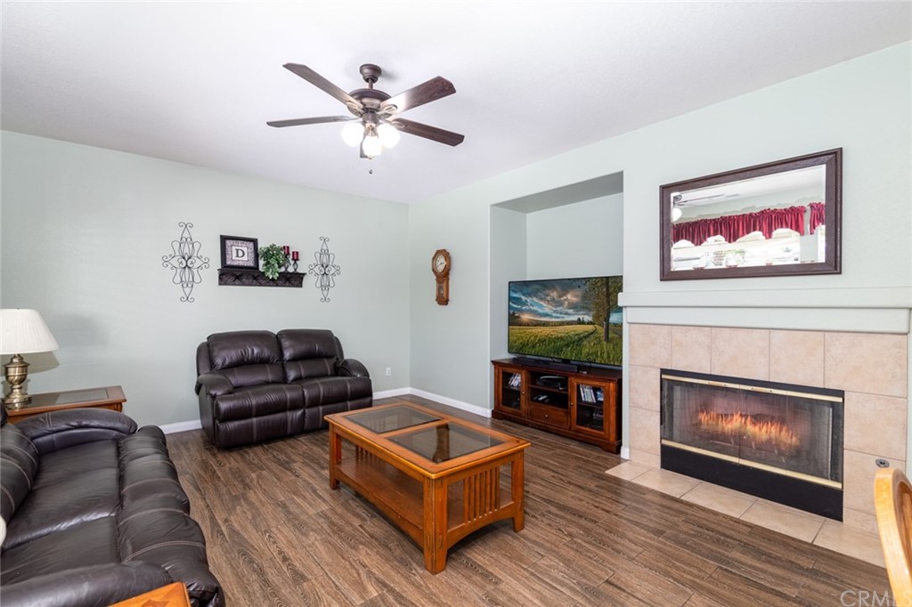 23746 Fieldcrest Lane Murrieta, CA 92562 - Photo 16 of 54 a living room with furniture a flat screen tv and a fireplace