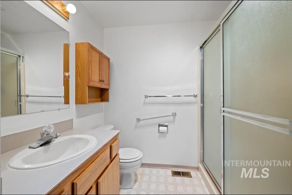 1128 Burrell Avenue, Unit 2 Lewiston, ID 83501 - Photo 12 of 24 Full bath featuring tile patterned floors, vanity, and an enclosed shower