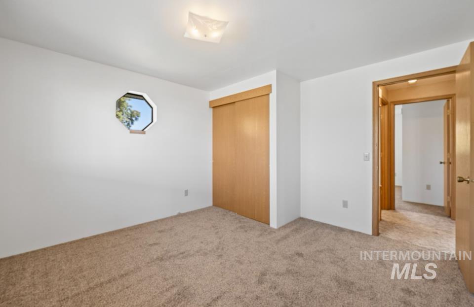 1128 Burrell Avenue, Unit 2 Lewiston, ID 83501 - Photo 13 of 24 Unfurnished bedroom with carpet and a closet