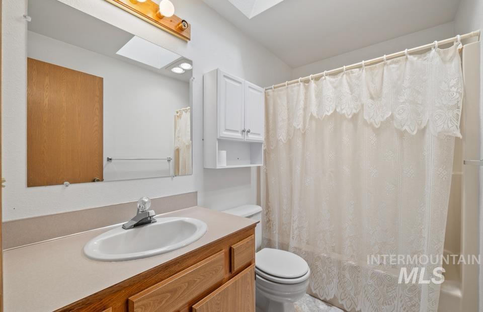 1128 Burrell Avenue, Unit 2 Lewiston, ID 83501 - Photo 14 of 24 Bathroom featuring vanity and shower / bathtub combination with curtain