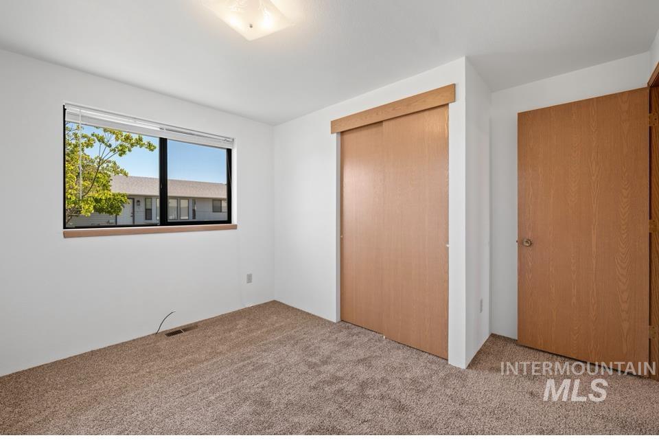 1128 Burrell Avenue, Unit 2 Lewiston, ID 83501 - Photo 15 of 24 Unfurnished bedroom with carpet flooring and a closet