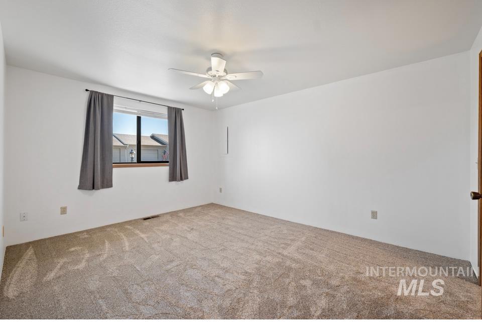 1128 Burrell Avenue, Unit 2 Lewiston, ID 83501 - Photo 18 of 24 Carpeted spare room with ceiling fan
