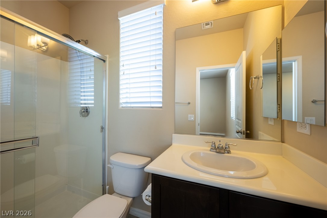 11016 Prairie Grove Road Las Vegas, NV 89179 - Photo 29 of 37 A well-appointed bathroom with a clear glass shower enclosure and a vanity with ample counter space.
