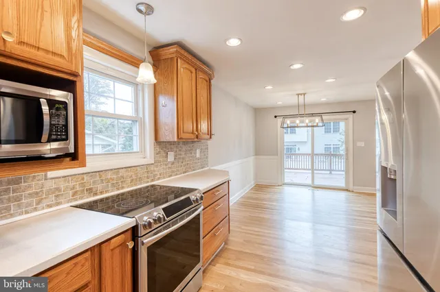a kitchen with granite countertop a stove and a sink