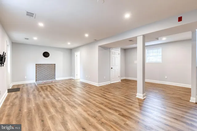 a view of an empty room and wooden floor