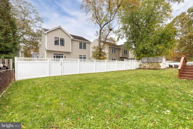 a view of a yard with table and chairs and wooden fence