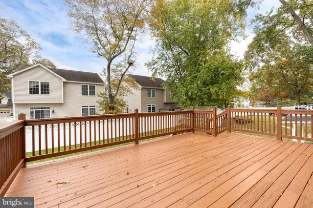 a view of a wooden deck and a yard