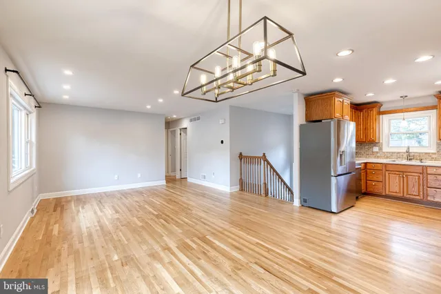 a view of a kitchen with a sink and a refrigerator