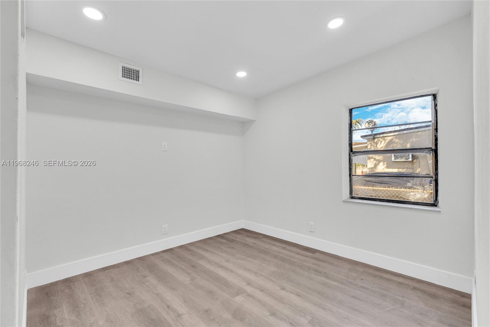 2330 Rutland Street Opa-Locka, FL 33054 - Photo 14 of 29 a view of empty room with wooden floor and fan