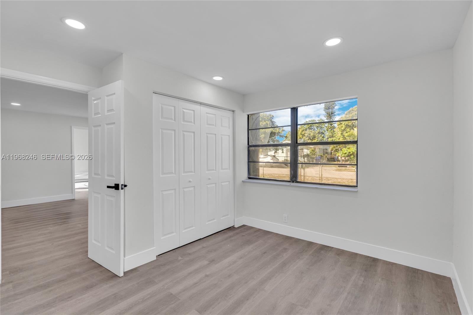 2330 Rutland Street Opa-Locka, FL 33054 - Photo 18 of 29 an empty room with wooden floor and windows