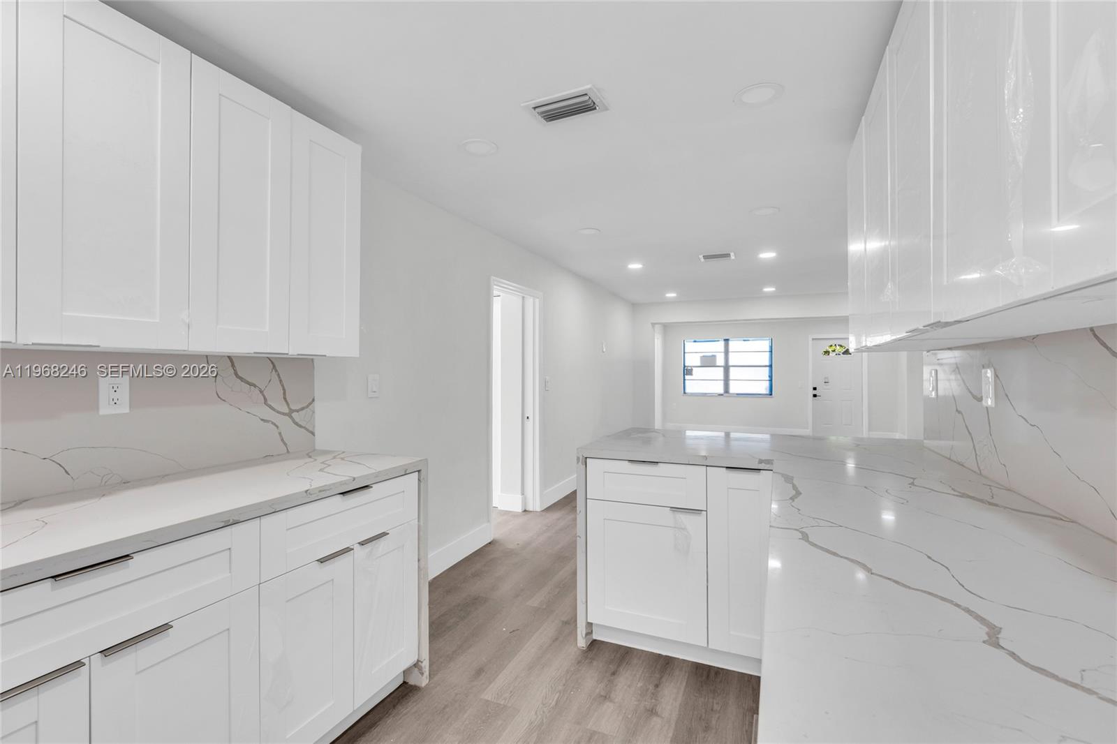 2330 Rutland Street Opa-Locka, FL 33054 - Photo 19 of 29 a view of a kitchen counter space with stainless steel appliances wooden floor and cabinets