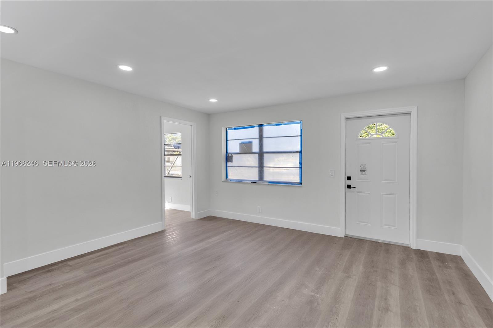 2330 Rutland Street Opa-Locka, FL 33054 - Photo 23 of 29 an empty room with wooden floor and windows
