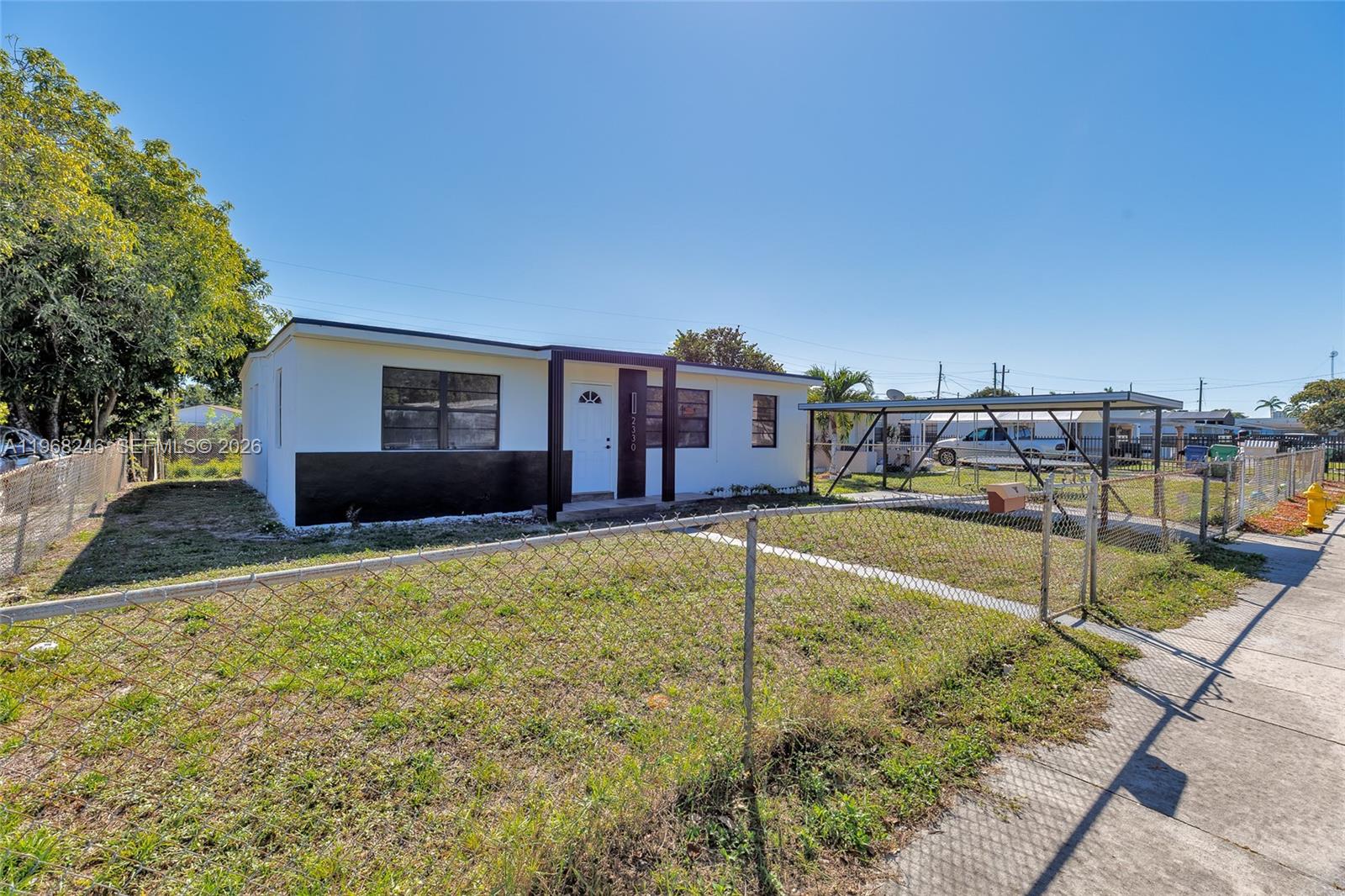 2330 Rutland Street Opa-Locka, FL 33054 - Photo 26 of 29 a swimming pool with a yard