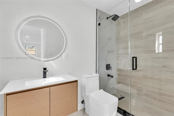 a bathroom with a sink toilet and shower