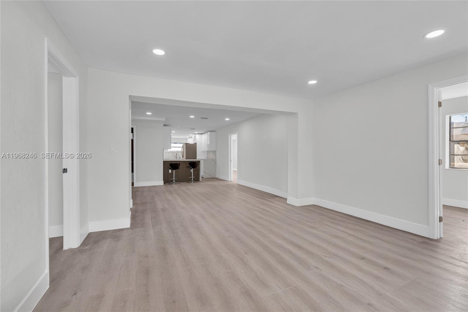 2330 Rutland Street Opa-Locka, FL 33054 - Photo 9 of 29 wooden floor in an empty room with a window