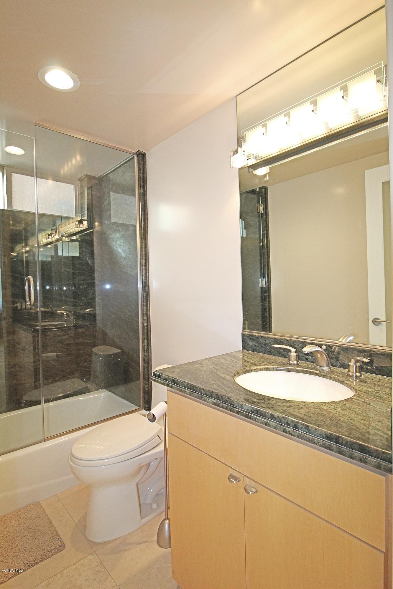 3629 Ocean Drive Oxnard, CA 93035 - Photo 18 of 60 a bathroom with a granite countertop sink toilet and shower