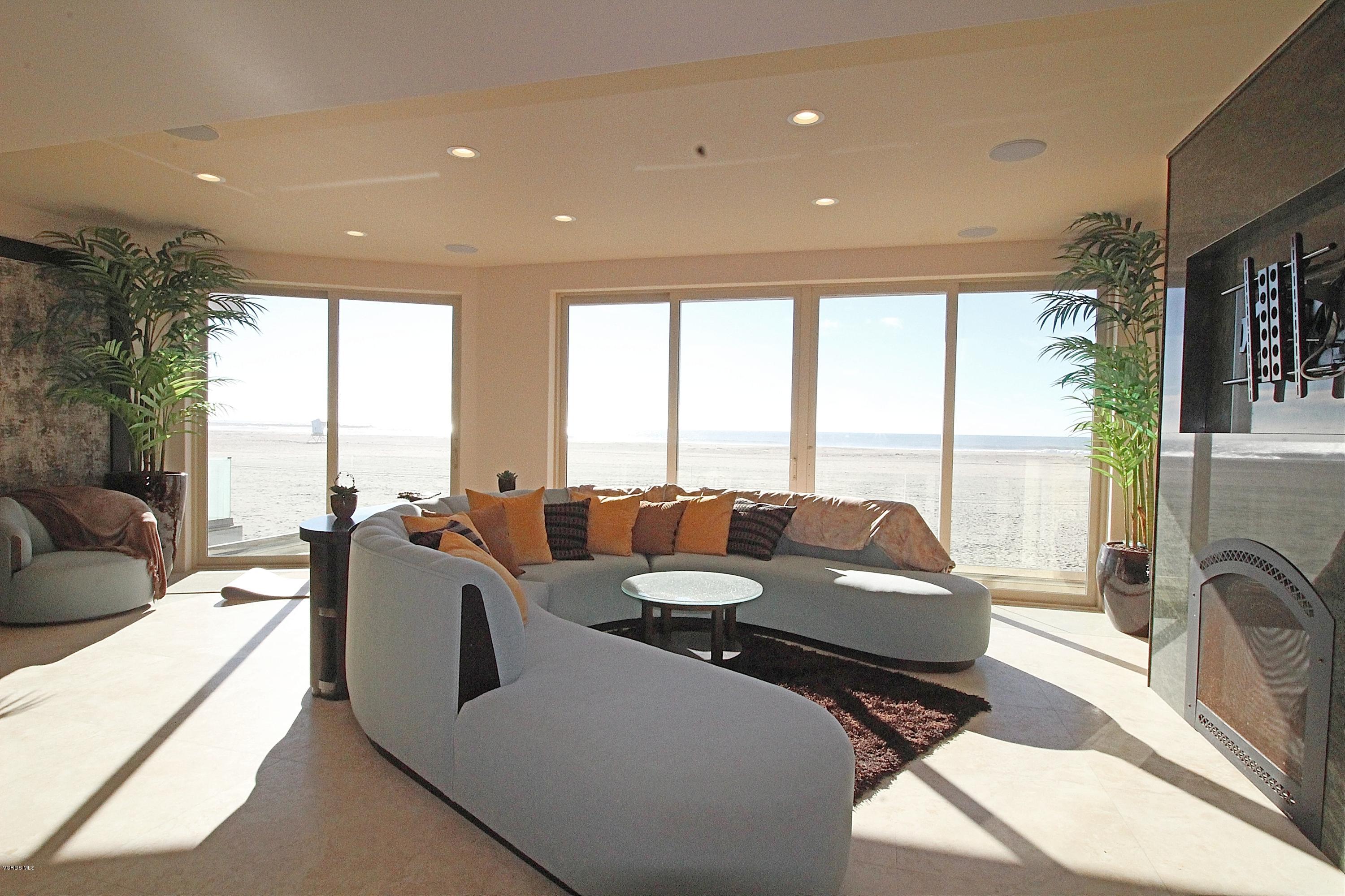 3629 Ocean Drive Oxnard, CA 93035 - Photo 20 of 60 a living room with furniture fireplace and floor to ceiling windows