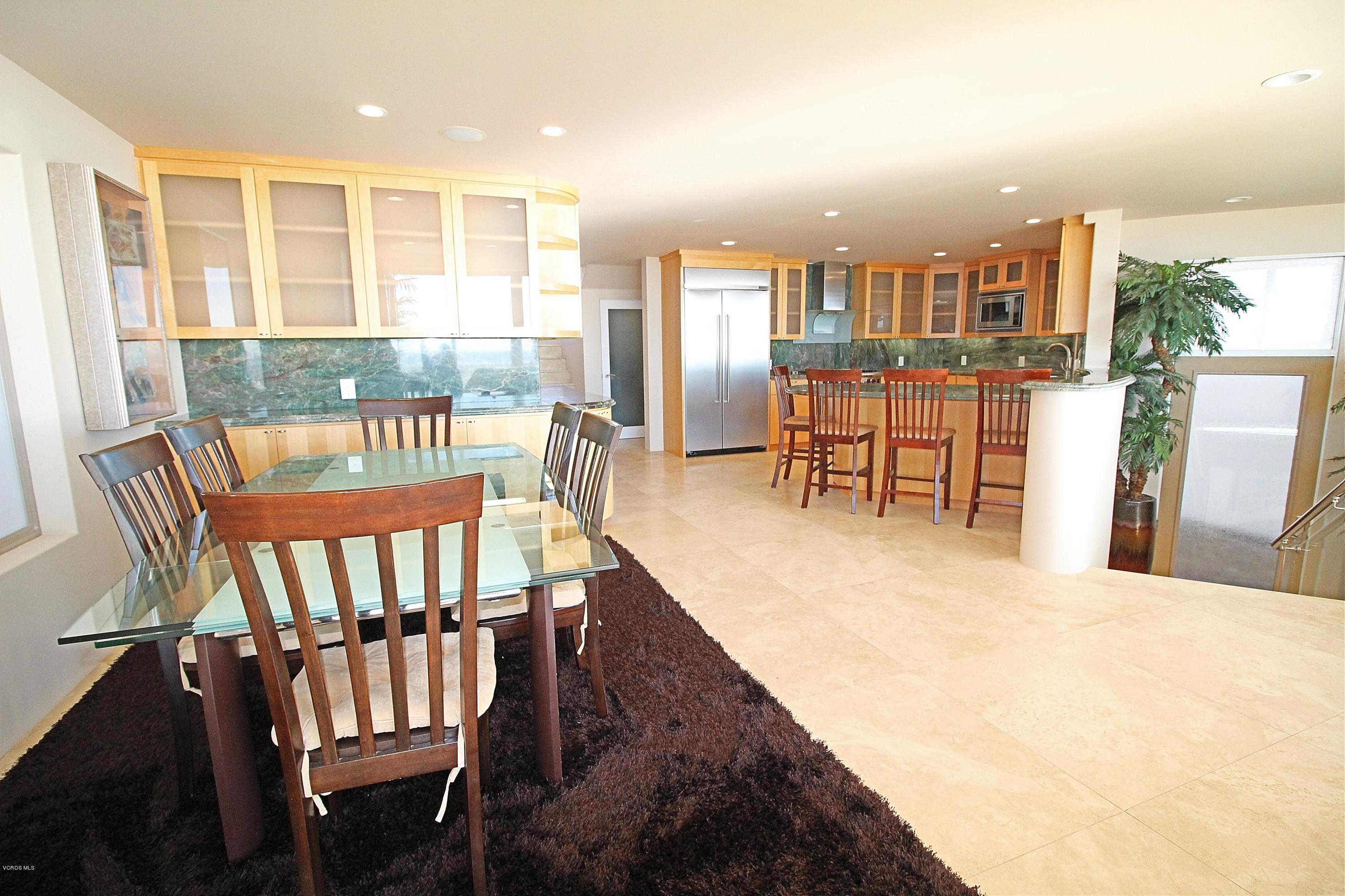 3629 Ocean Drive Oxnard, CA 93035 - Photo 24 of 60 a dining room with furniture and a floor to ceiling window