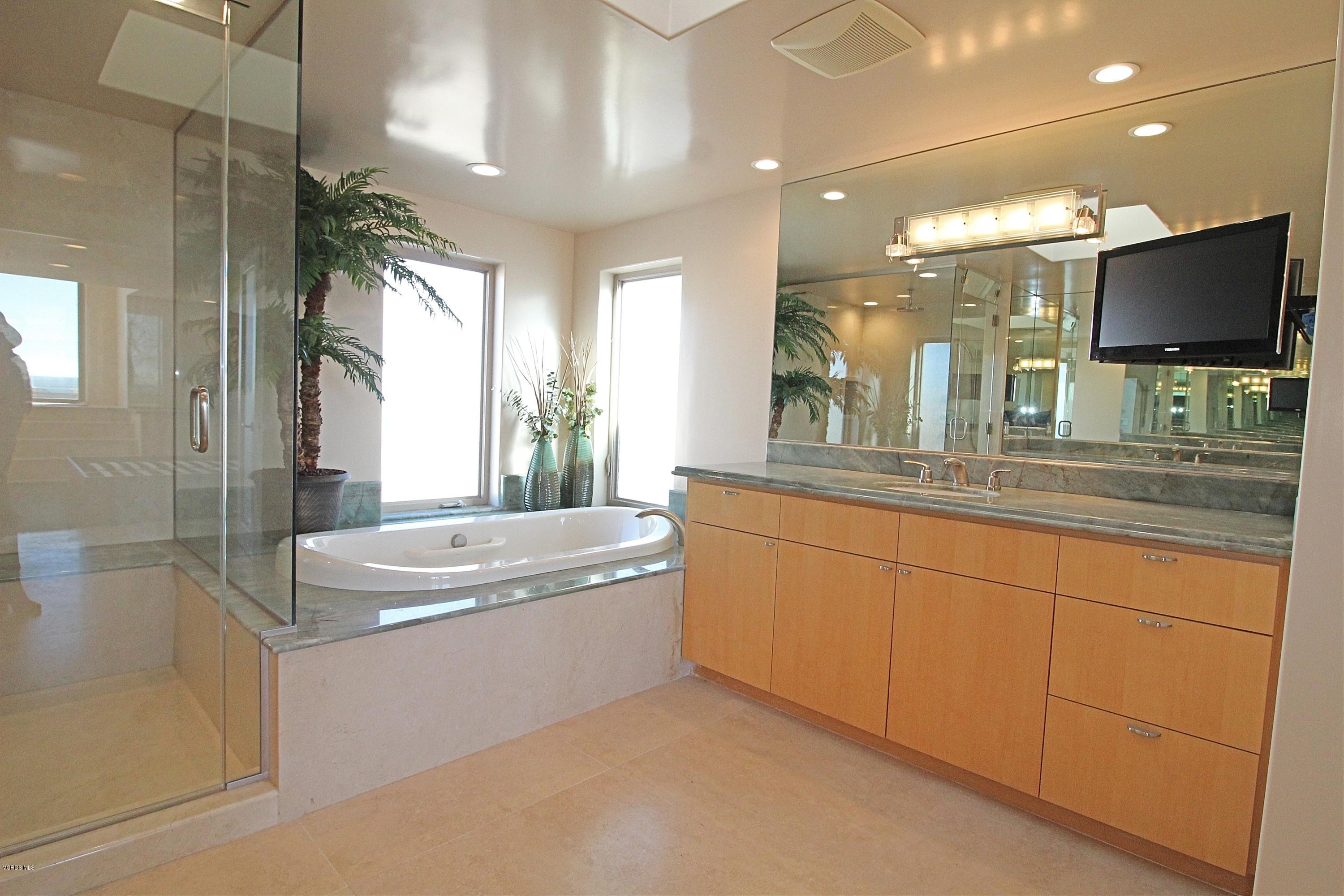 3629 Ocean Drive Oxnard, CA 93035 - Photo 36 of 60 a spacious bathroom with a large tub sink and mirror