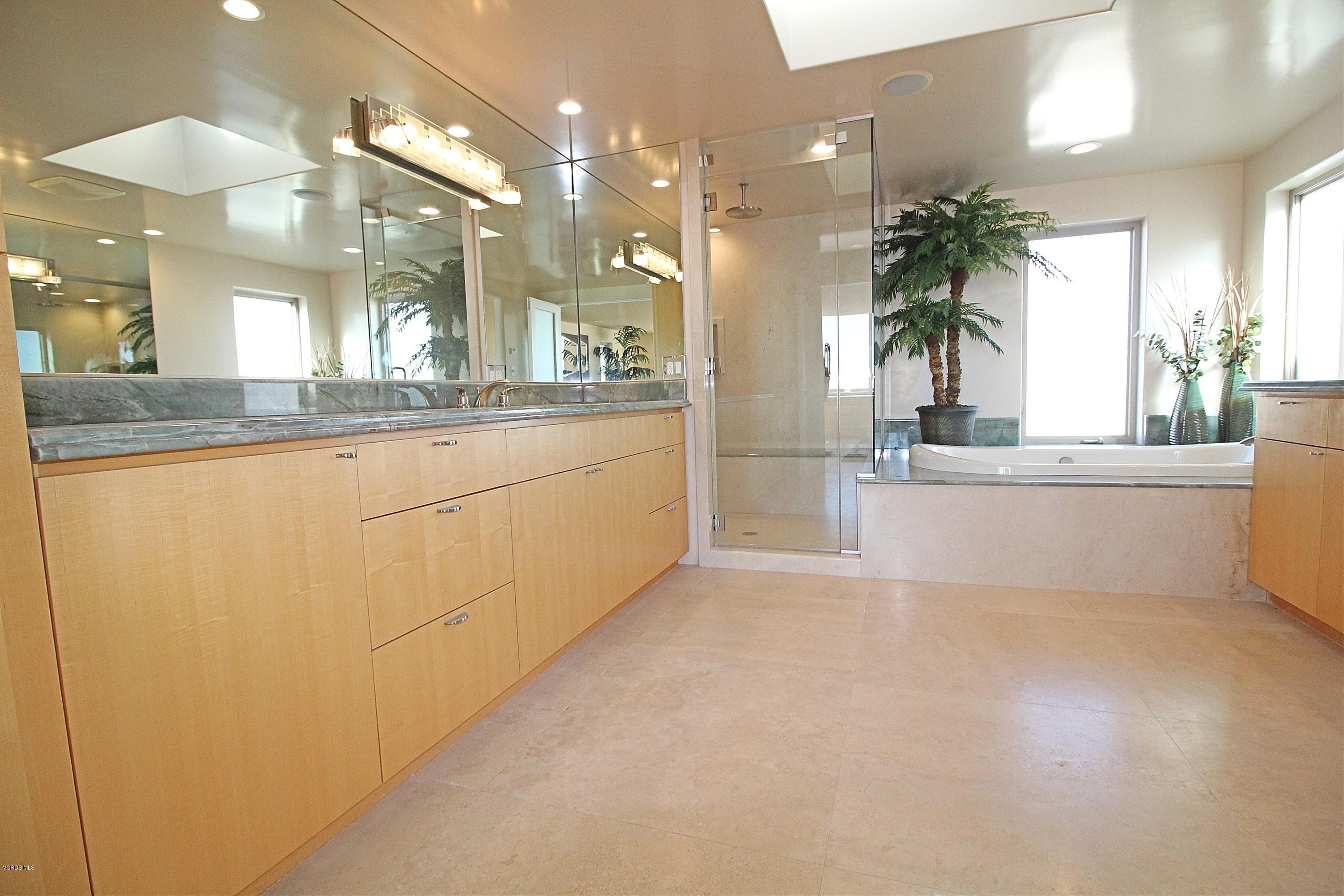 3629 Ocean Drive Oxnard, CA 93035 - Photo 54 of 60 a large white kitchen with granite countertop a sink and a large mirror