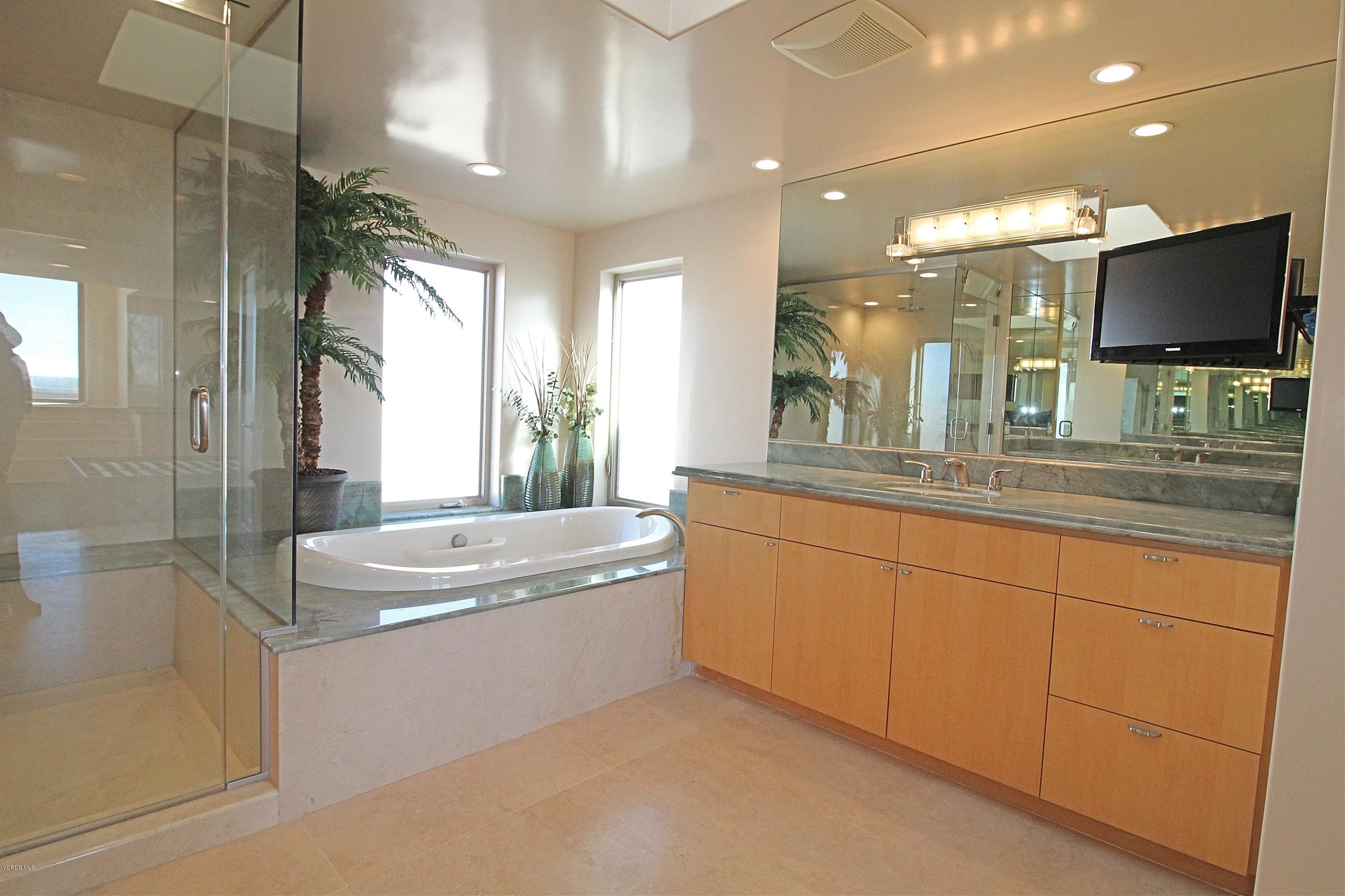 3629 Ocean Drive Oxnard, CA 93035 - Photo 55 of 60 a spacious bathroom with a large tub sink and mirror